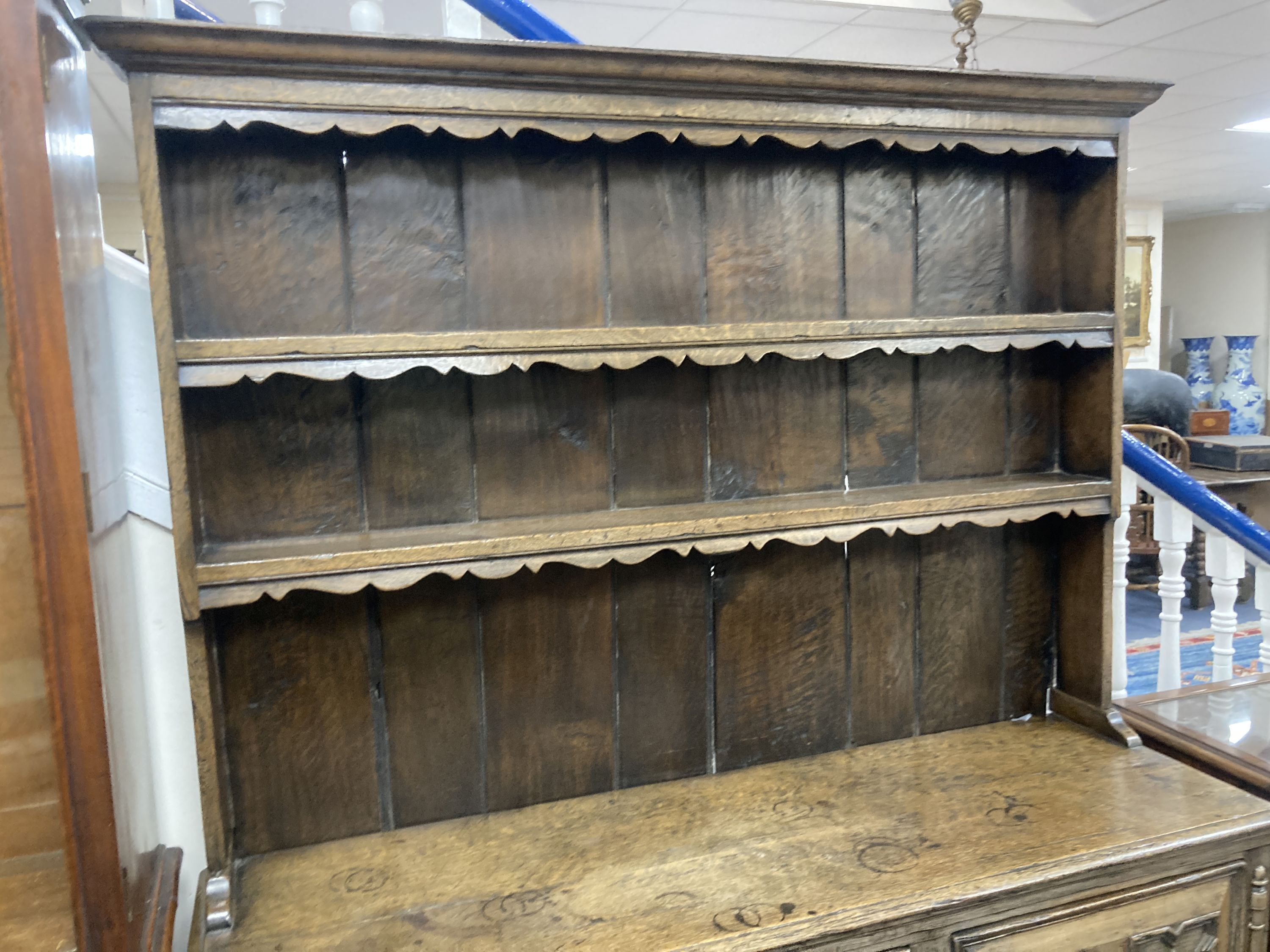 An early 20th century Jacobean style oak dresser, width 150cm, depth 47cm, height 199cm